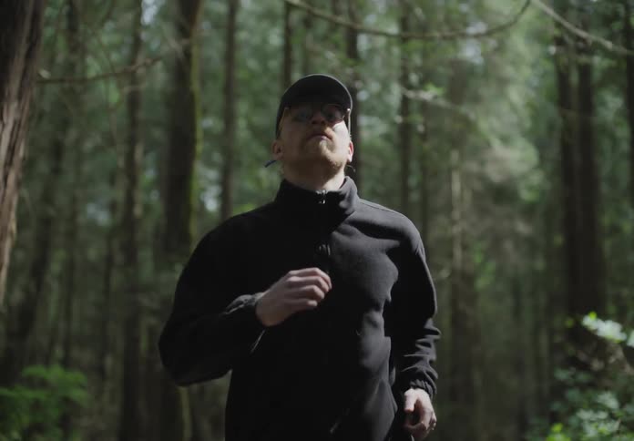 Male jogging alone on a hiking trail through the woods