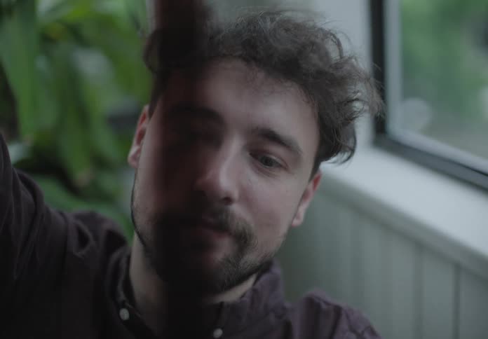 A man in a room looking at a filmstrip