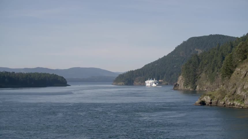 A boat can be seen docked near the shore in the distance