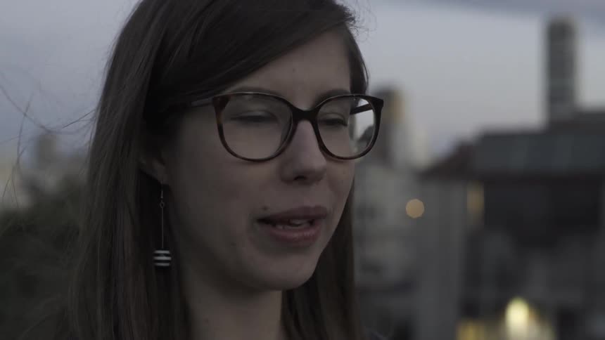 A woman is talking as she holds a phone in front of her face