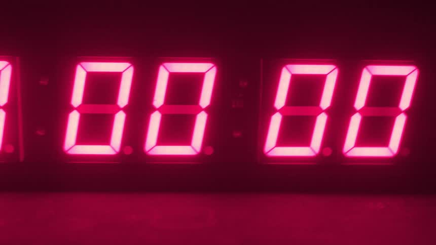 A neon clock counts down to zero