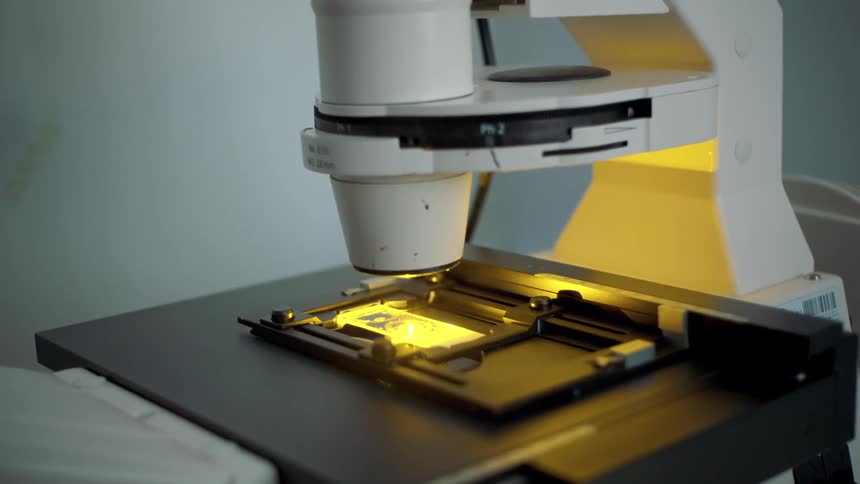 A machine emits yellow and green light