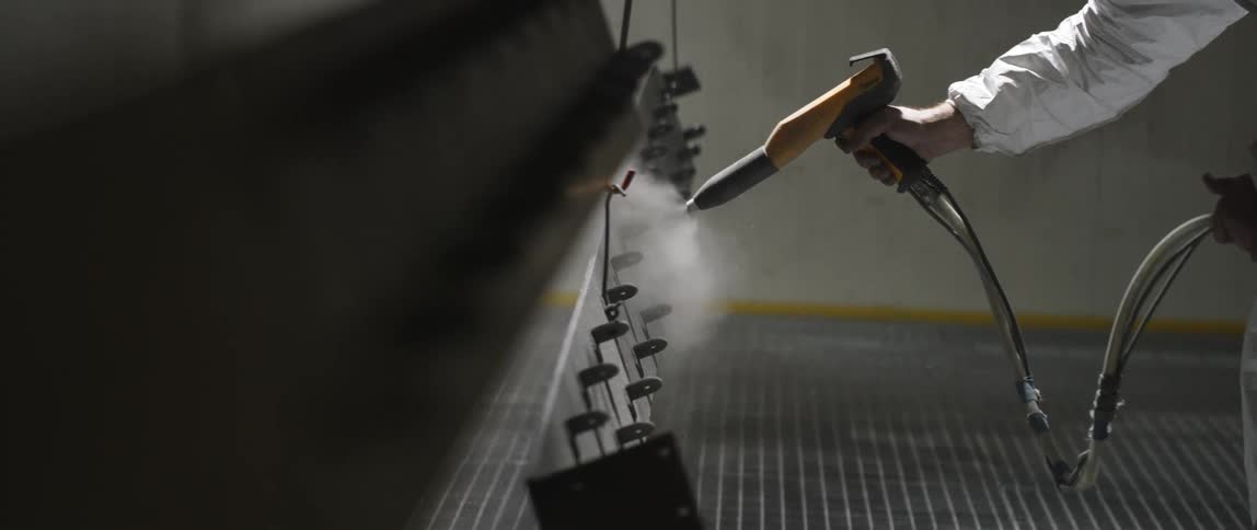 A white male with a sprayer mists a machine