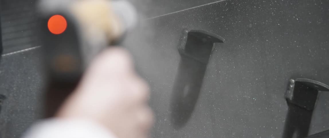 A man uses a pressure washer