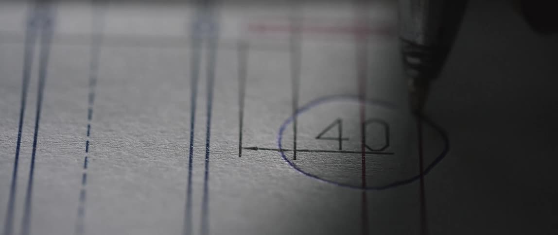A person circles a number on some paperwork