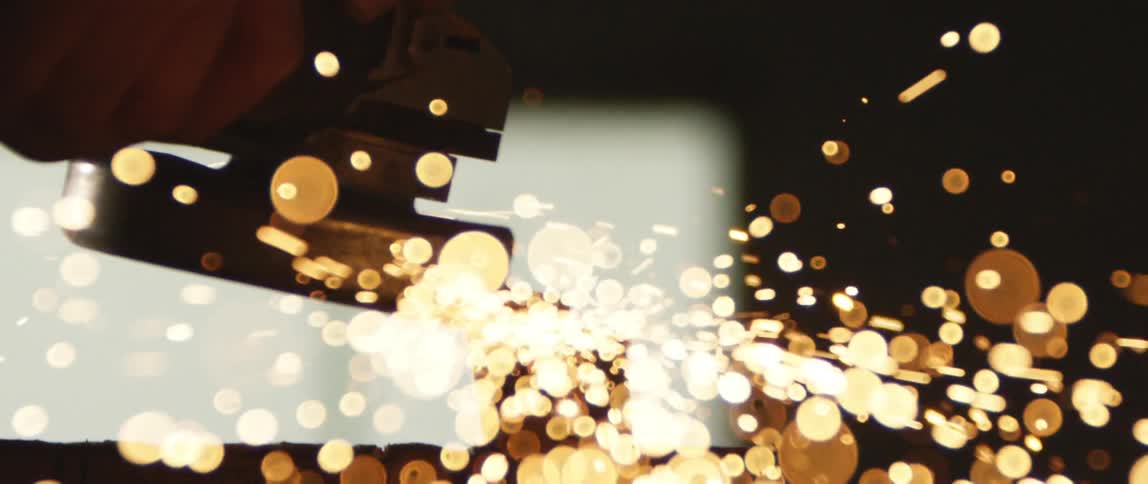 Sparks fly off a tool in a factory