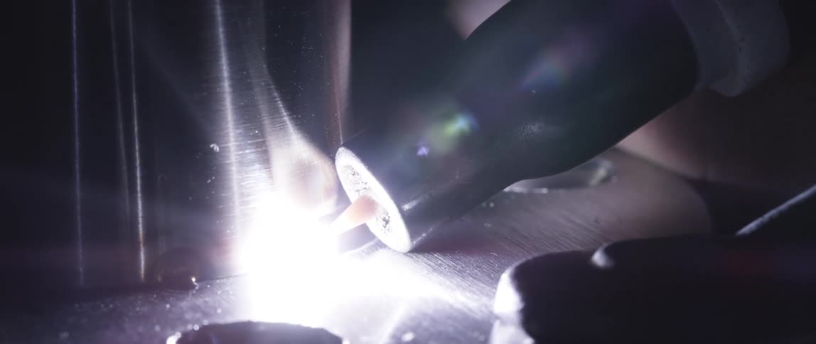 Light and flame coming out of a tool in a factory
