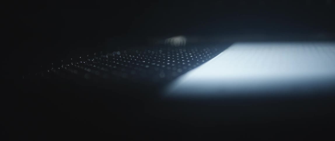 Out of focus close up of a rugged surface on a dimly lit space