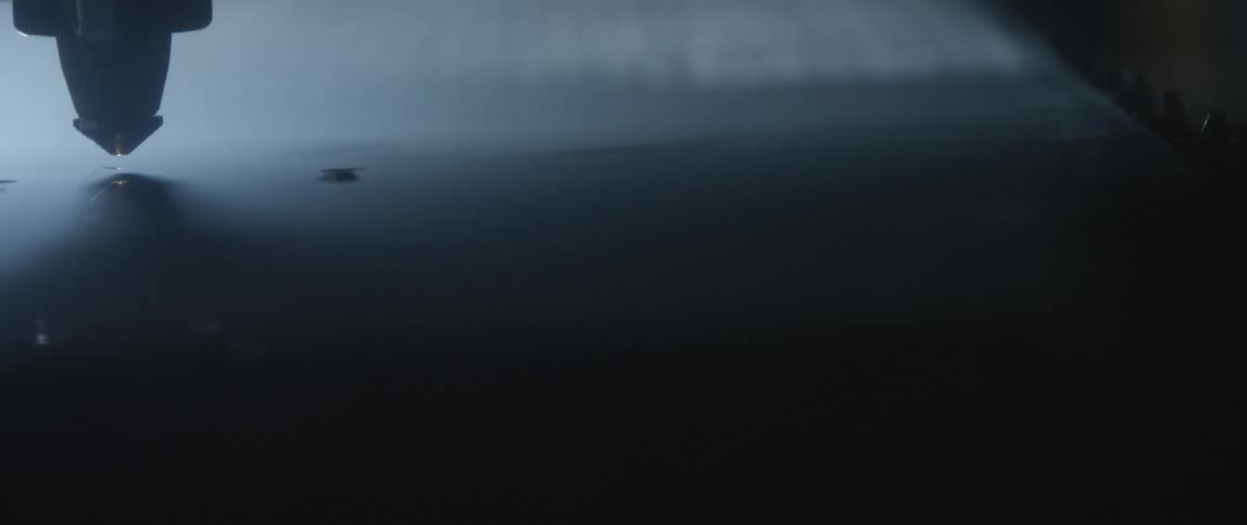 A spark coming out of the tip of a tool in a factory