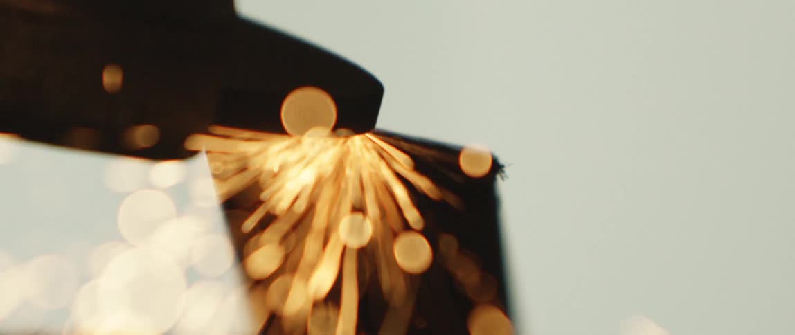 Power tool grinding on metal produces a shower of sparks