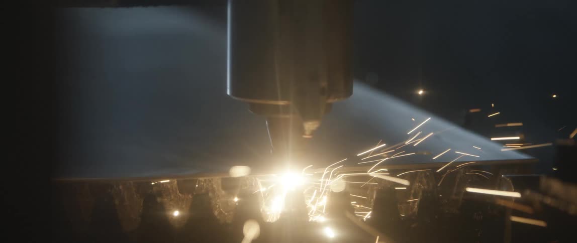 Sparks glow and fly as a power tool cuts and shapes metal