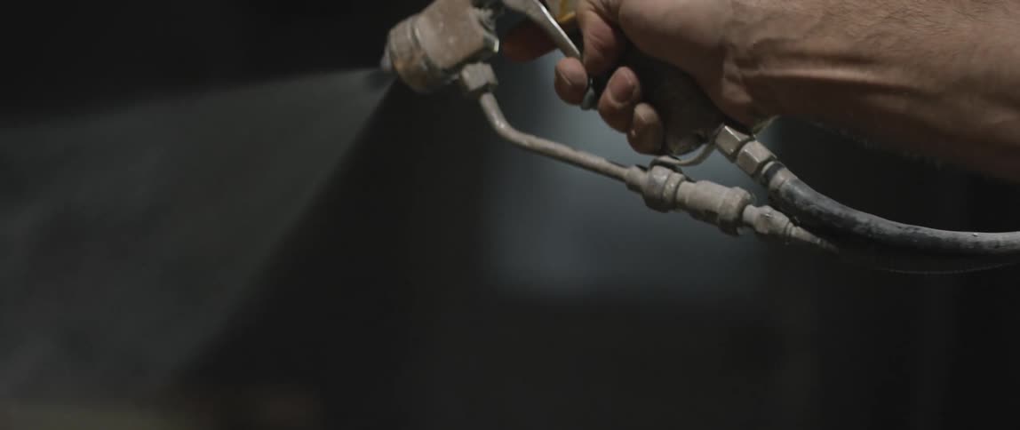 A white man sprays mist with a sprayer
