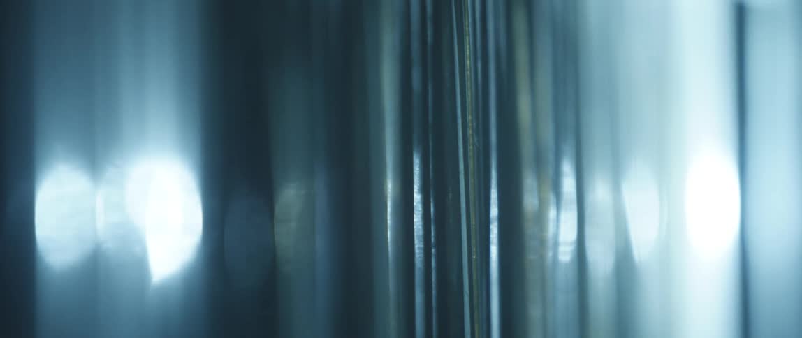 Light filtering through clear plastic sheet hanging from the ceiling