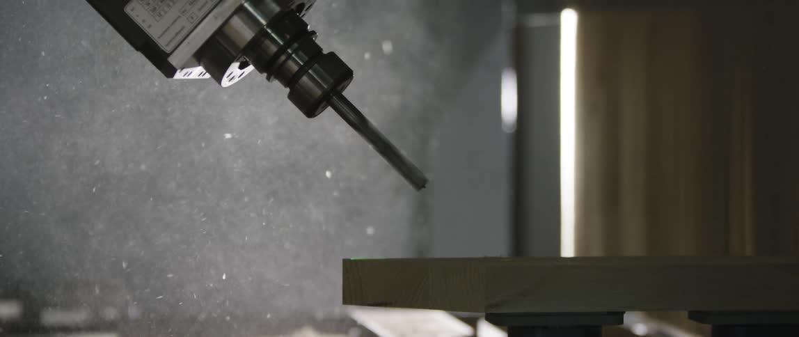 Computer numerical control machine drilling a piece of wood
