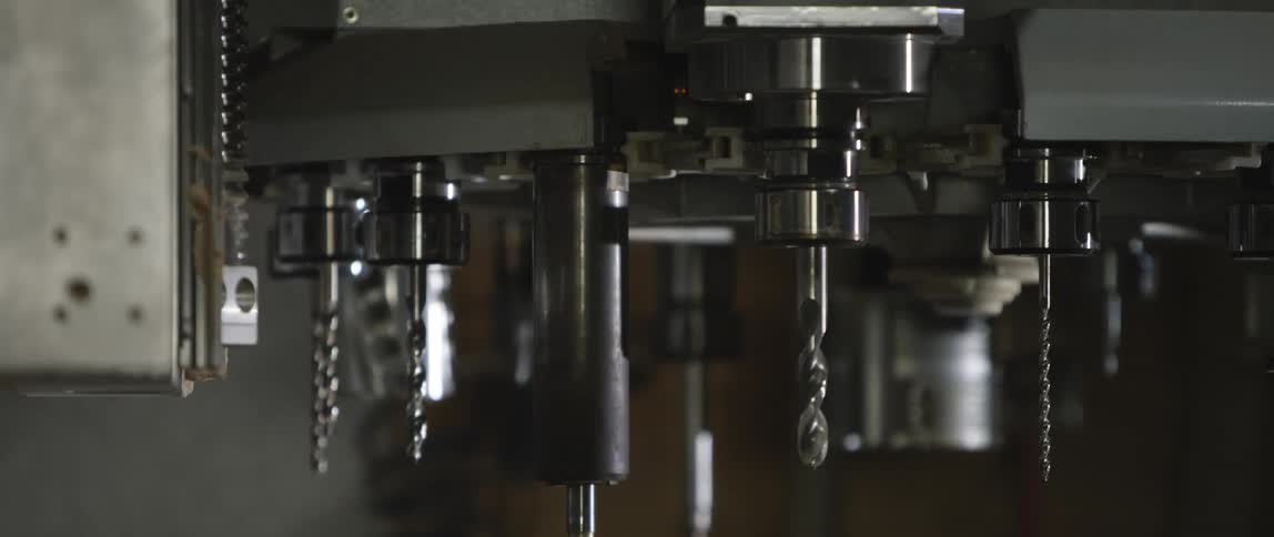 A machine with drill bits in a factory