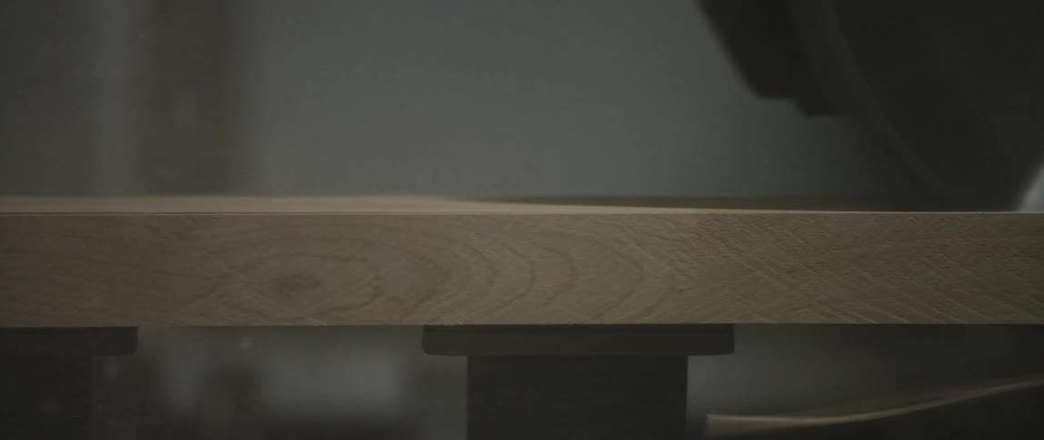 The table saw cuts the sheet of plywood