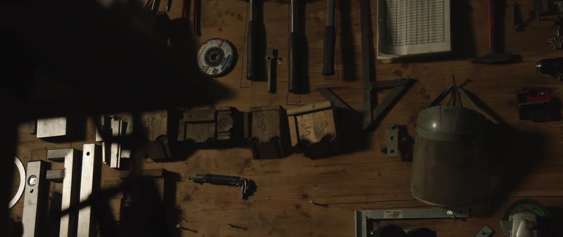 Tools hanging on the wooden wall of a workshop