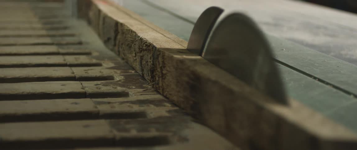 Two saw blades cut the long wood