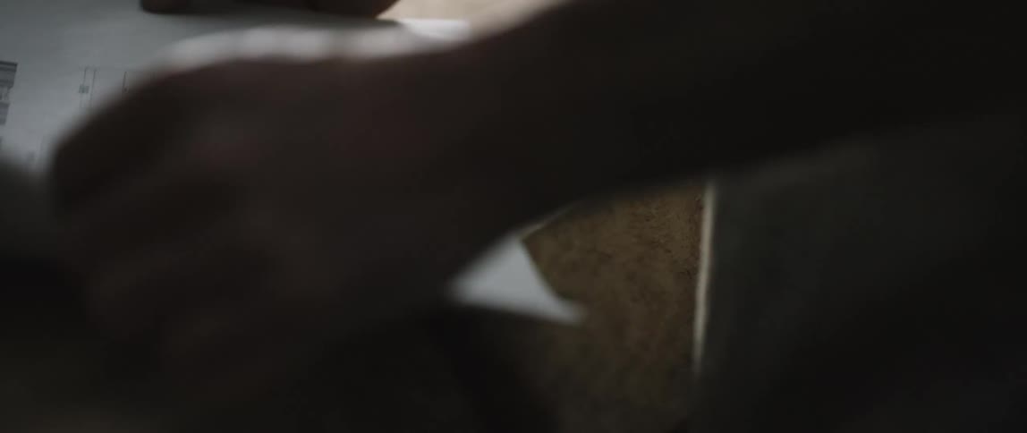 A man placing pieces of paper on a table