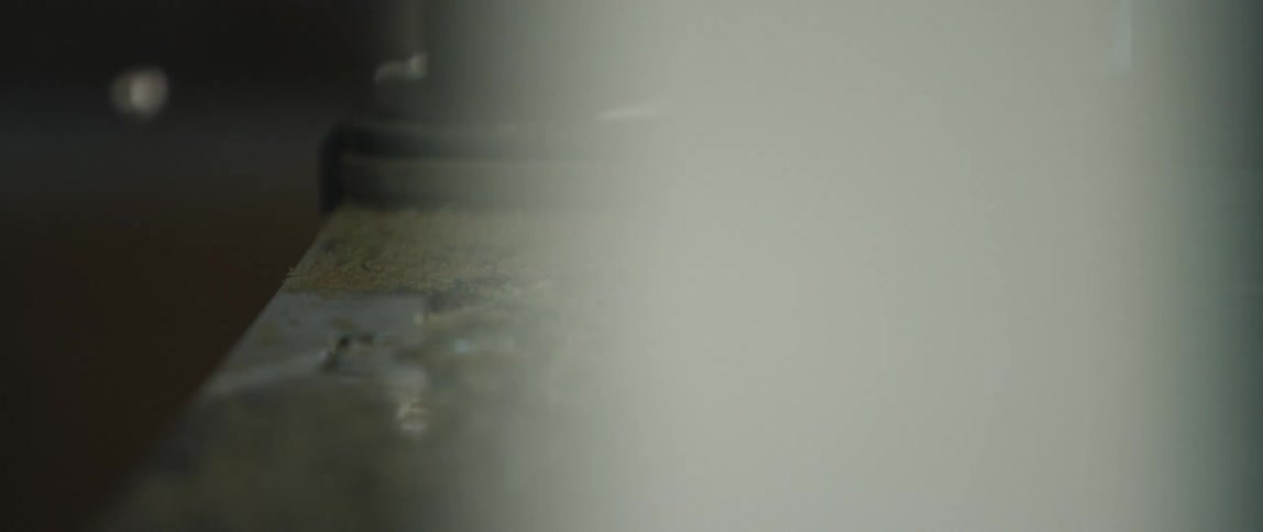 A person walks past a pillar in a city