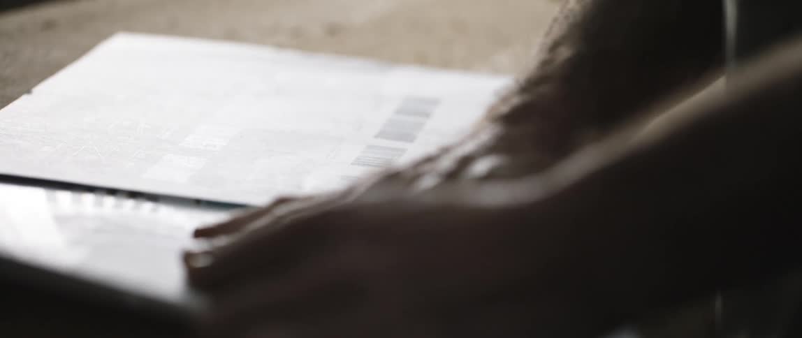 A man is looking at pieces of paper