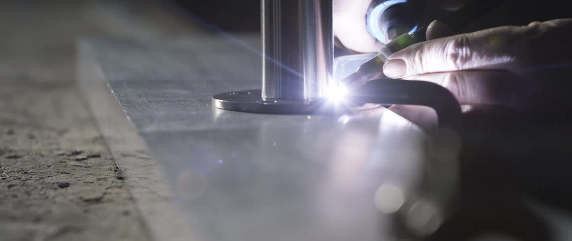 A man uses a tool that light shines out of