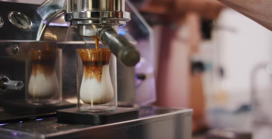 A person is making coffee in a restaurant