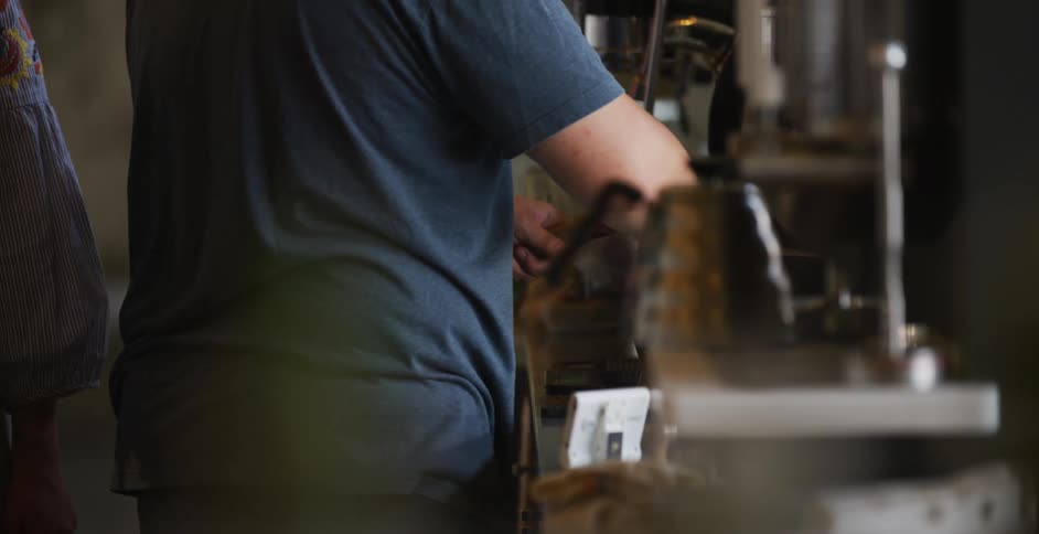 A man is preparing coffee in the cafe