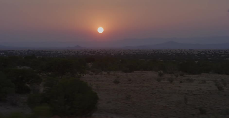 The sun sets in the distance