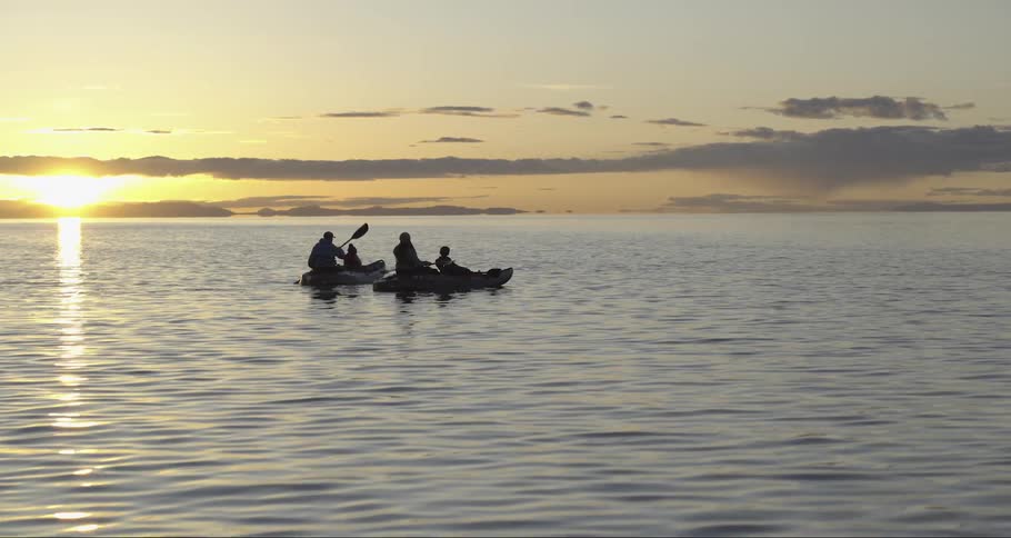 A group of people go boating in two small canoes