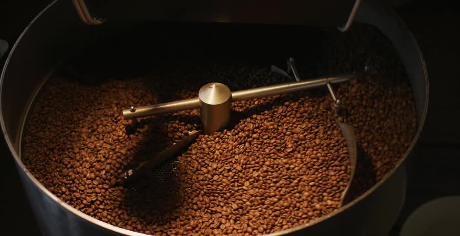 Coffee beans being stirred in a factory