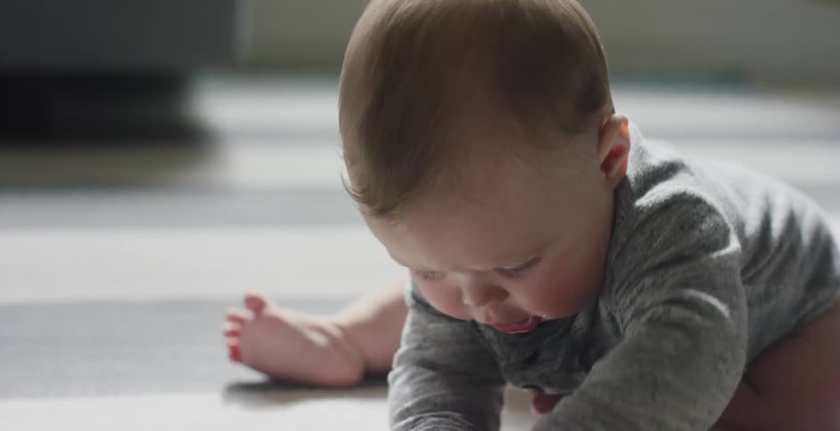 A baby is playing with toys on the carpet