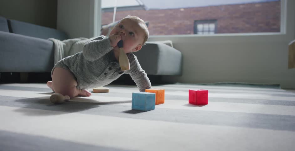 A baby plays on the floor
