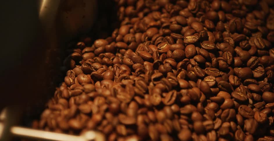 Person uses coffee roasting machine for the coffee beans