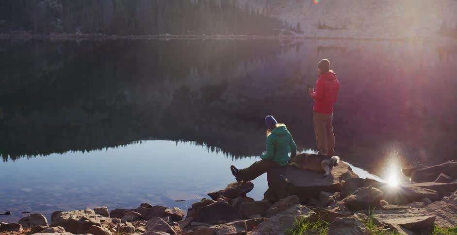Man and woman stand by the lake
