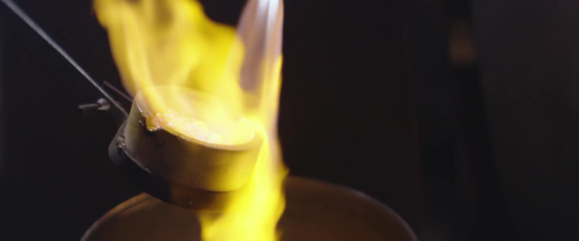 Torch melts metal in crucible