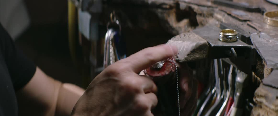 A jeweler examines a stone