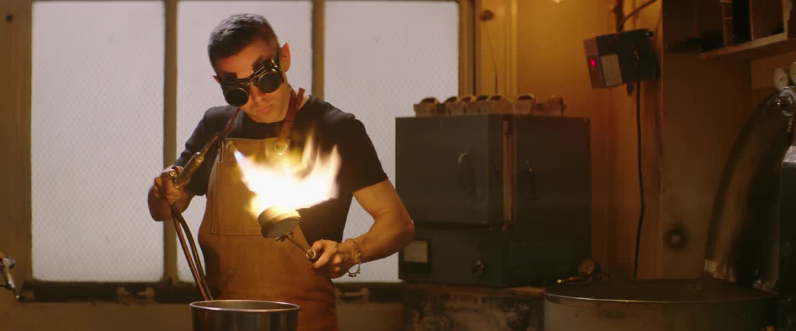 A man with safety glasses torches metal 2