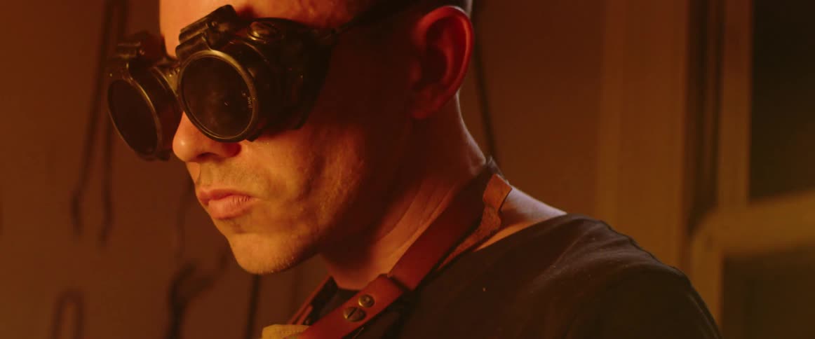 A man concentrates while torching metal in workshop