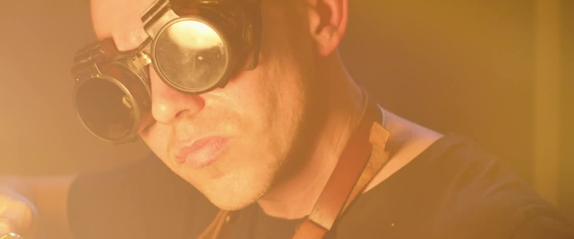 A man concentrates as he torches in workshop