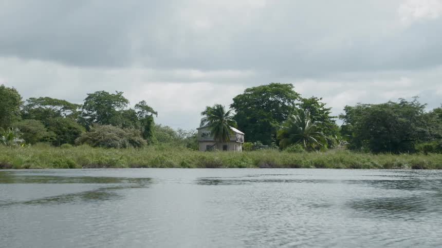 Wide shot of a house by a lake