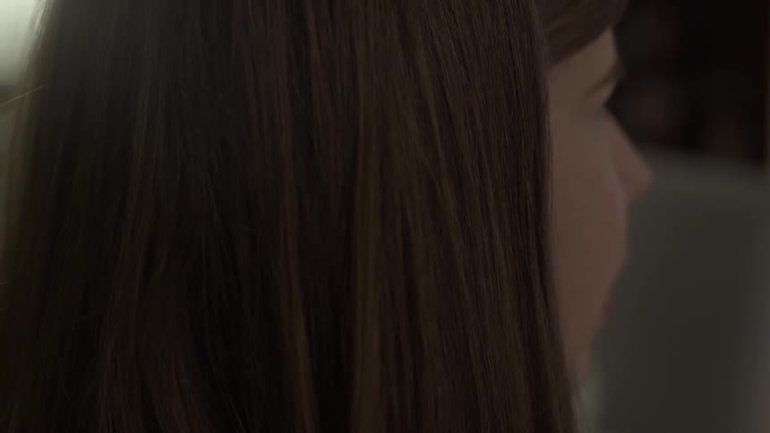 Young brunette woman speaking with someone out of view