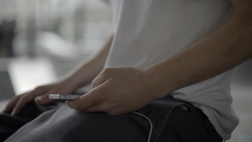 Man scrolling through phone screen outdoors with calm everyday digital vibe.