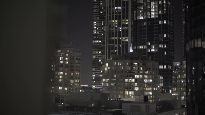 Creeping view of a city high-rises at night
