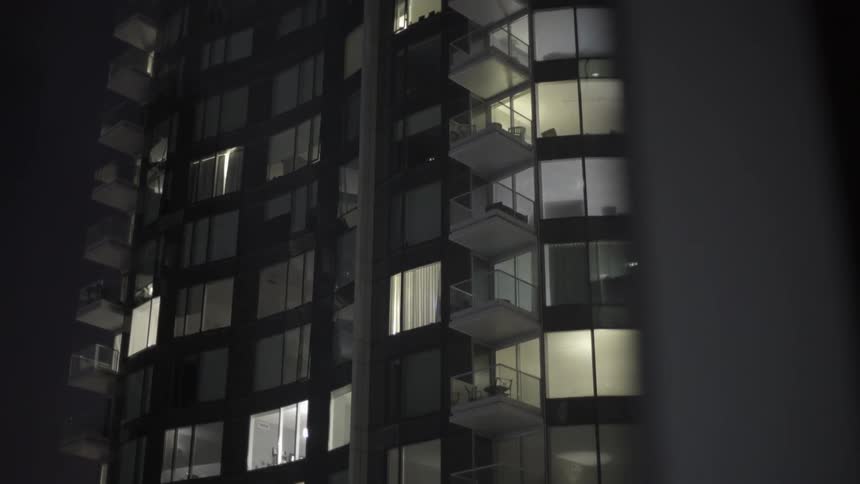 The exterior of a high-rise apartment building seen at night