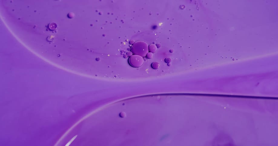 Colorful liquid ink floating on water on abstract patterns