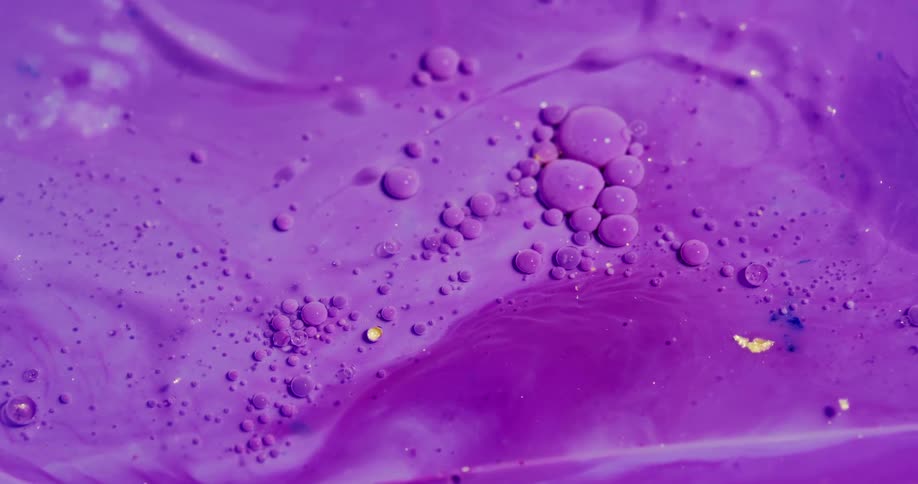 A purple fluid flows and bubbles