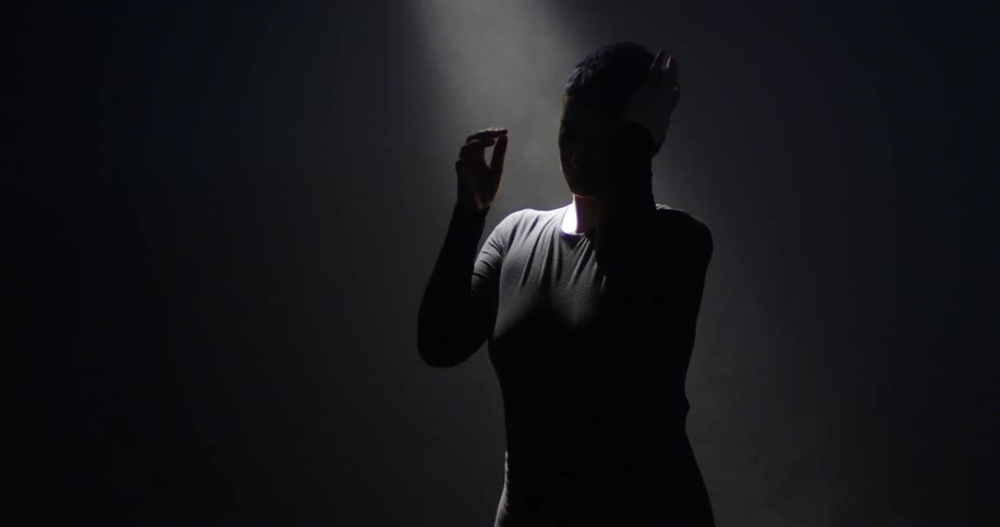 A person standing in a dark room