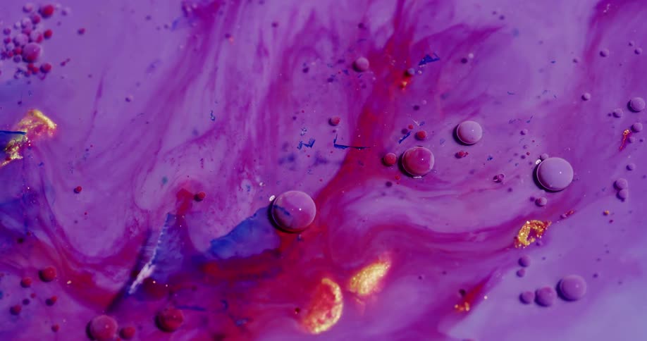 A purple liquid flows with bubbles in it