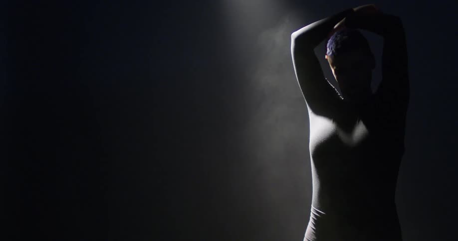 A woman is dancing at night